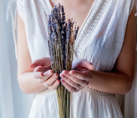 canva woman in white dress holding lavender bouquet MAEPywfeHnc