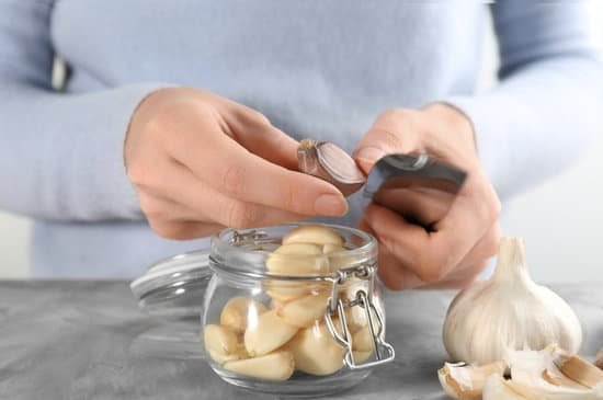 canva woman peeling garlic at table MAD76qNU Q8
