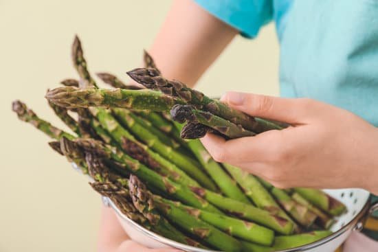 canva woman with fresh asparagus closeup MAD8y8wftzs