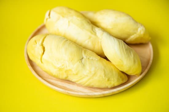 canva wooden plate of ripe peeled durian on yellow background MAD7b7XTZTQ