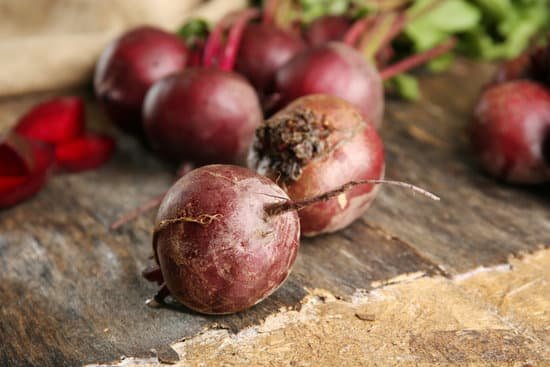 canva young beets with leaves on wooden table MAD MSDGbNA