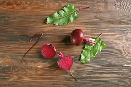 canva young beets with leaves on wooden table MAD MUAk318