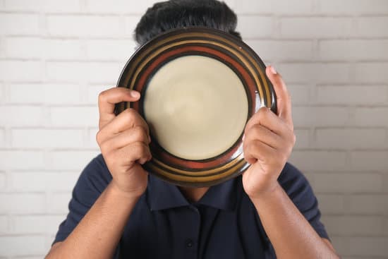 canva young man hiding his face with plate MAEYXns1GCE