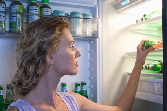 canva young woman looking for food in fridge MADBP r5zr0