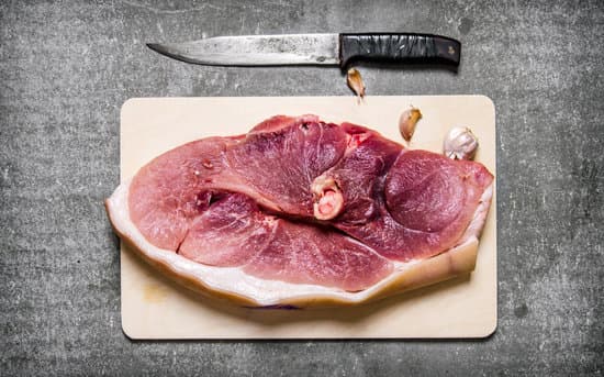 canva a piece of raw fresh meat with a chopping knife. MAESn4OKseA