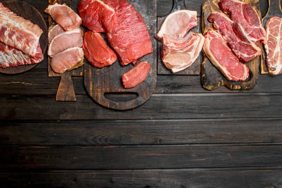 canva assortment of raw meat on wooden boards