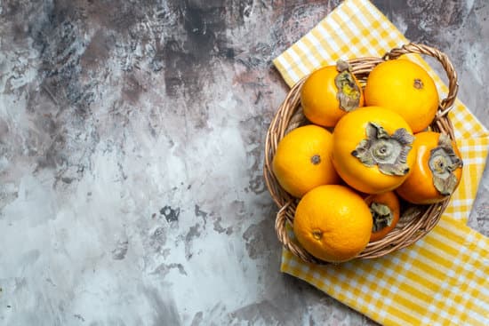 canva basket of fresh persimmons on concrete background MAEQcvAQXwc