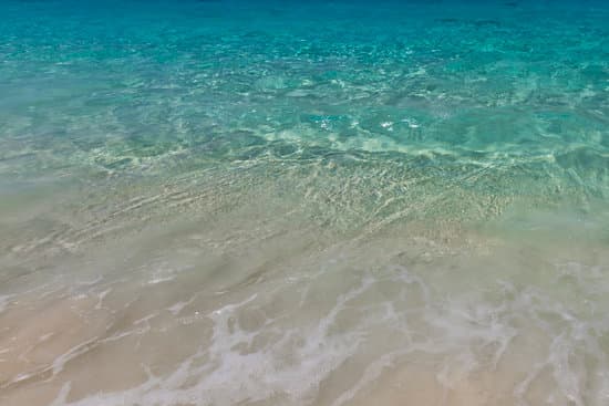 canva blue sea on sandy beach MAERgakt4ak