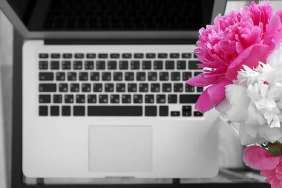 canva bouquet of beautiful peonies and laptop on a table MAD9bTR80K4