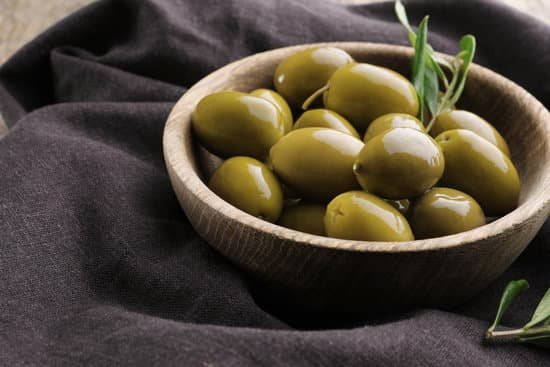 canva bowl with green olives on cloth MAD9T8bhSWo