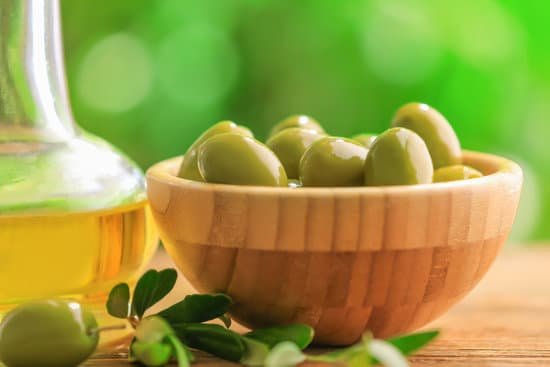 canva bowl with healthy olives on blurred background