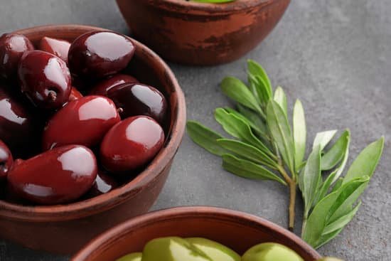 canva bowl with healthy olives on kitchen table closeup MAD9T5ng0sU