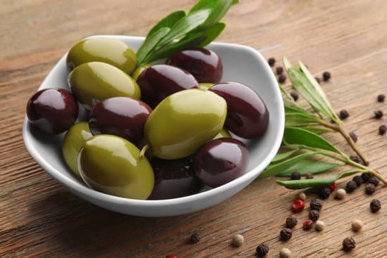 canva bowl with olives on wooden table MAD9T6hfVnA