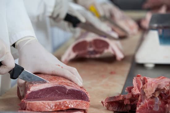 canva butcher cutting meat at meat factory MADaspzOiRQ