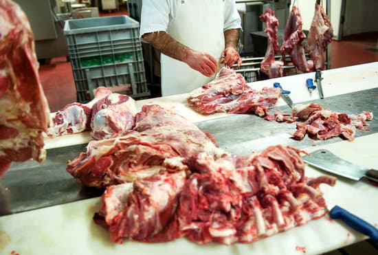 canva butcher working in a butchery with meat MAEPRflU1sw