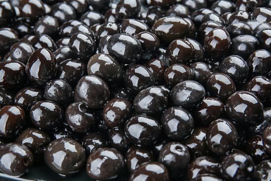canva canned black olives as background