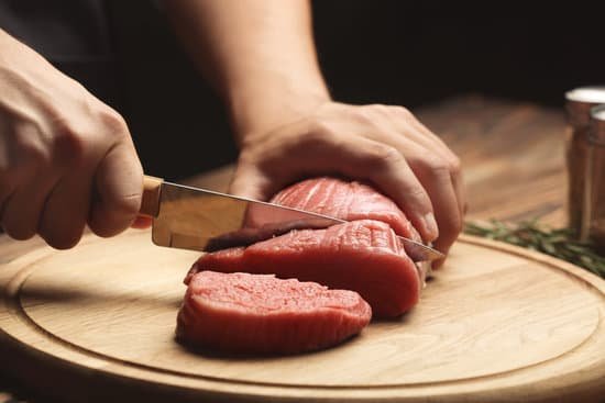 canva chef cutting fresh raw meat on wooden board MAD9T3sIH7I