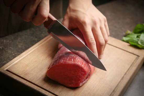 canva chef cutting fresh raw meat on wooden board MAD9T8SNgi4