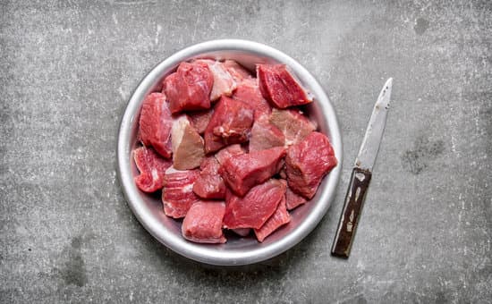 canva chopped raw meat in a bowl with a knife MAESpEF7oE0