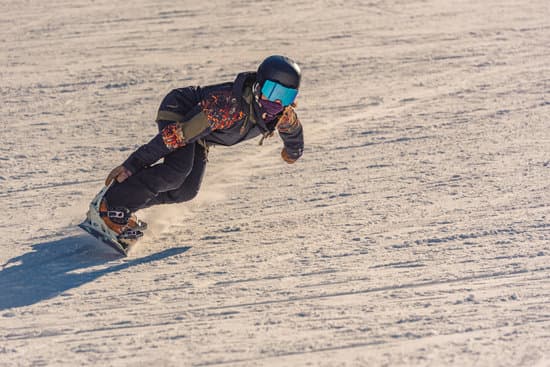 canva closeup of a female snowboarder in motion on a snowboard in a mountain