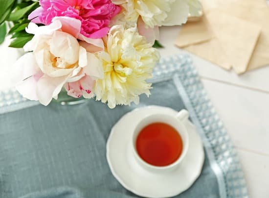 canva composition with peony flowers and cup of tea on table MAD Q3D LvY