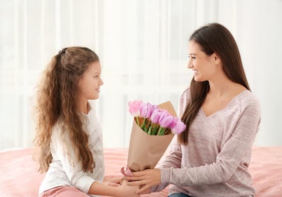 canva cute little girl giving tulip bouquet to her mom indoors MAD9W