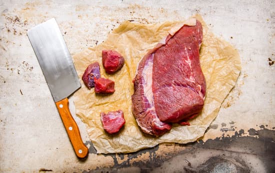 canva cutting fresh raw meat on paper. on rustic background. MAESmyBL0uA