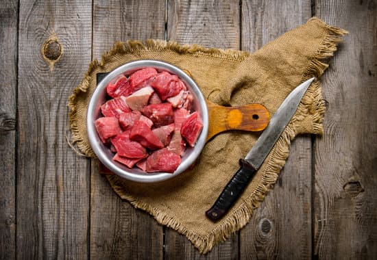 canva cutting raw meat with a large knife MAESqIUrHpo
