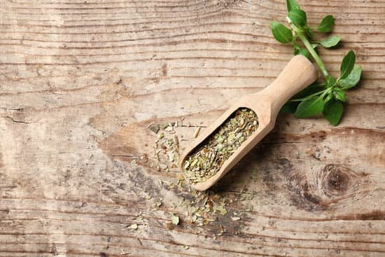 canva dried oregano on a wooden scoop MAD9Tx upMo
