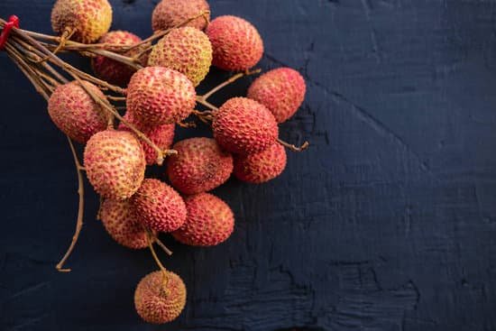 canva fresh lychee fruit on a black wooden background MAEGvU2VZ00