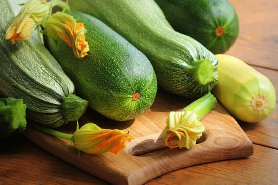 canva fresh organic zucchini on the wooden table MAEDROFEWPc