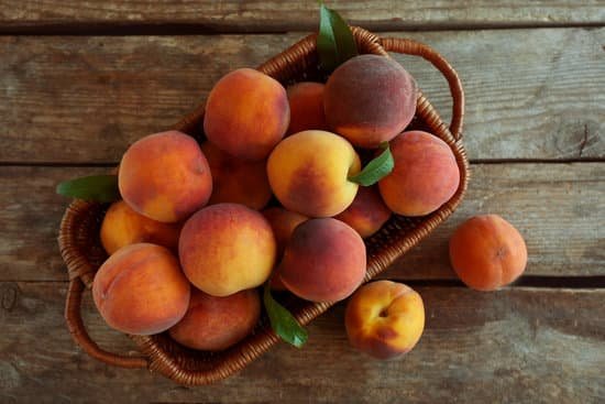 canva fresh peaches in a basket on wooden background MAD Q0C7gBA