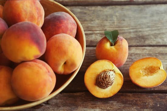 canva fresh peaches in a bowl on wooden background MAD Q6pAuf0