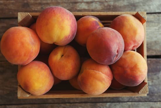 canva fresh peaches in a box on a wooden background MAD Q1WqBpc