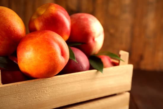 canva fresh peaches in a crate up close MAD MtoHQgw