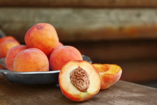 canva fresh peaches in a plate on a wooden background MAD Q58NGGg