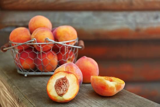 canva fresh peaches in basket on wooden background MAD Q2LR2EU