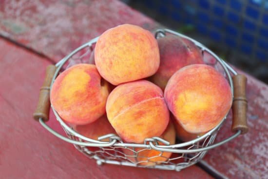 canva fresh peaches in basket on wooden background MAD Qw9aJyw