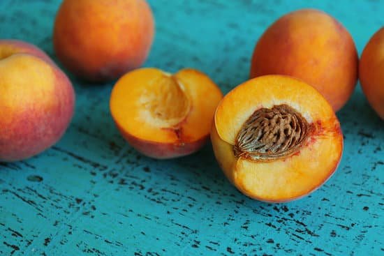 canva fresh peaches on a blue wooden background MAD Q gqb8Q