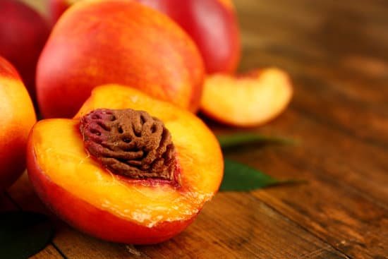 canva fresh peaches on wooden background MAD MrDH8D4