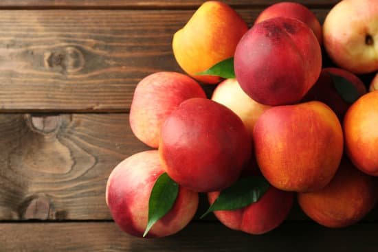 canva fresh peaches on wooden table MAD MqN8