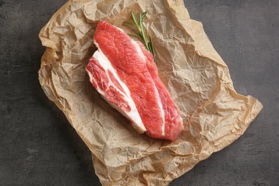 canva fresh raw meat with rosemary on parchment paper MAD9T KyQrY