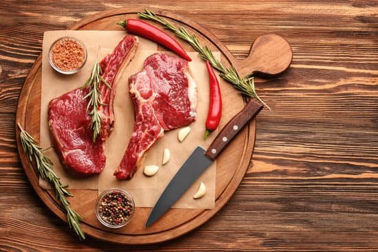 canva fresh raw meat with rosemary on wooden board MAD9T02golE