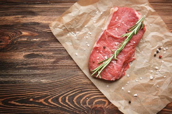 canva fresh raw meat with spice on parchment paper