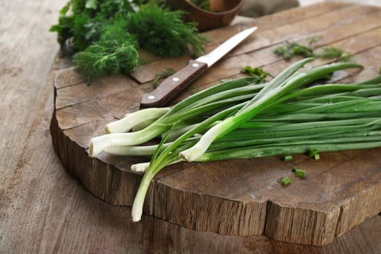 canva fresh scallions on wooden table MAD9USJ02Mo