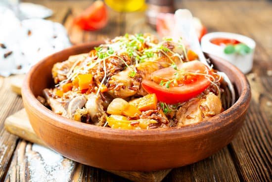 canva fried meat with rice in a wooden bowl
