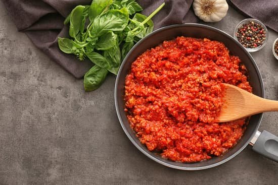 canva frying pan with meat sauce on a table