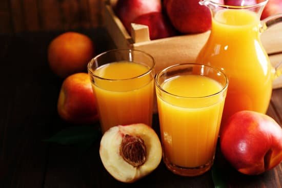 canva glasses of peach juice and ripe peaches on wooden background MAD MrbwmwA