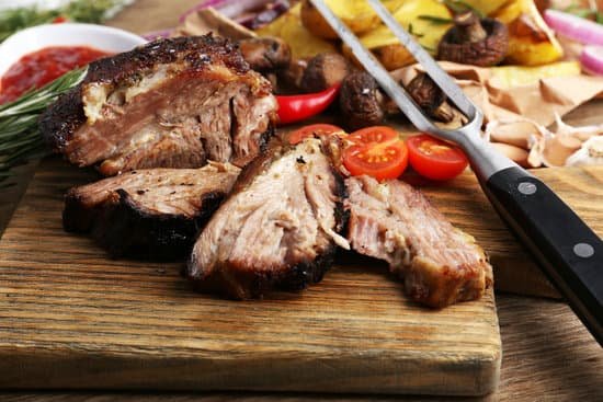 canva grilled meat and carving fork on a wooden board MAD L5auaEY