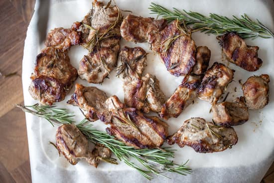 canva grilled meat and rosemary on parchment paper top view MAEThBEr6CI